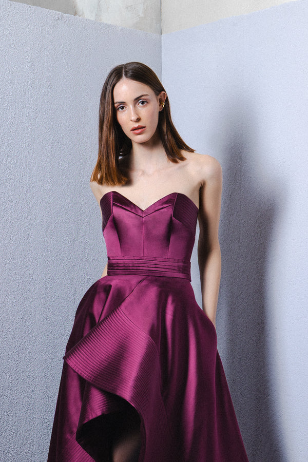 Strapless asymmetrical gown with signature belt