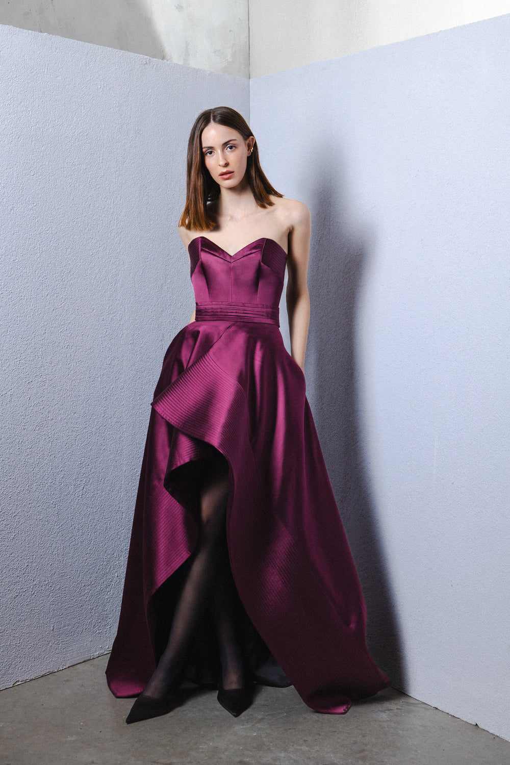 Strapless asymmetrical gown with signature belt